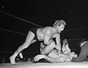 Prints of (Original Caption). Gorgeous George won in the end. To the delight of his admirers, George lowered the boom on Garbaldi, climbed back into his flashy robe and hairnet, and stalked off to the showers Grappling Through Time: A Visual Journey of Wrestling History: George The Wrestler in Action