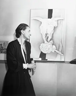 Georgia O'Keeffe Looking at Her Painting of Bleached Bones and Flowers