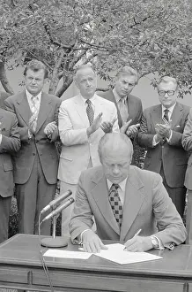 Gerald Ford Signing Document with Peers Nearby