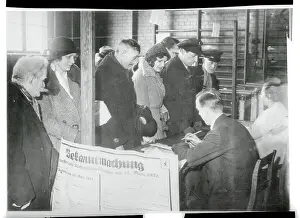 German Citizens Waiting at Desk for Voter Acknowledgment