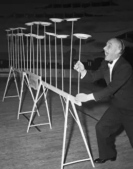 Balancing Prints: German Juggler Balances Plates On Sticks