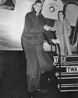 Giant Robert Wadlow Escorting Stewardess off of Airplane