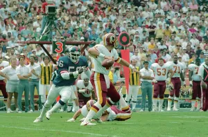 Quarterback Prints: Giants Linebacker Lawrence Taylor Rushing Redskins Quarterback