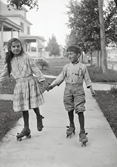 Pre Teen Girl Prints: Girl (10-12) and boy (8-9) roller skating
