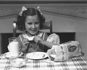 Girl (4-5) eating breakfast, (B&W)