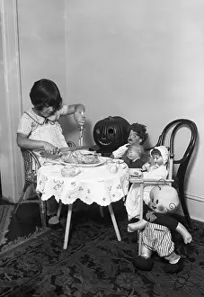 Dining Prints: Girl (6-7) dining with her dolls and toys