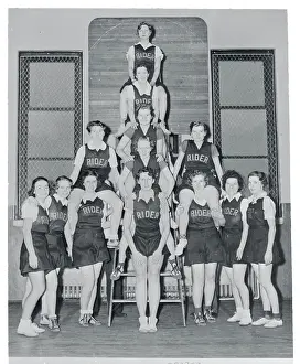 Prints of (Original Caption). The Girl's Varsity Basketball Squad of Rider College at Trenton, New Jersey, is shown as they posed in the college gym Hoops Through Time: A Visual Journey of Basketball History: Girl Basketball Team Posing for Camera