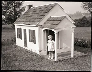 Frowning Prints: Girl In Dollhouse On Lawn