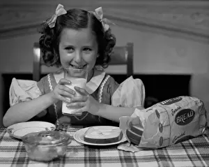 Girl drinking a glass of milk