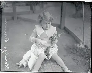 Alligator Prints: Girl Feeding Young Alligator with Small Bottle