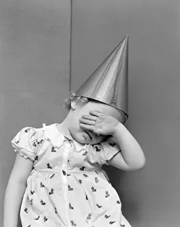 Girl With The Back Of Her Hand Covering Her Face Sitting In A Corner Wearing A Cotton