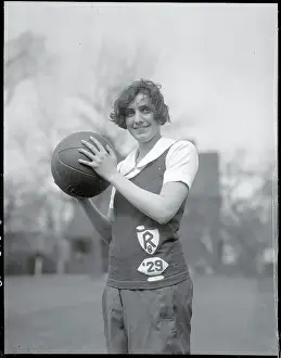 Prints of (Original Caption). She throws a mean basketball at Radcliffe Hoops Through Time: A Visual Journey of Basketball History: Girl Holding Basketball