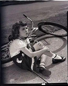 Injury Prints: Girl Holding Leg After Falling off Bike