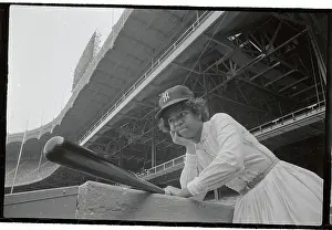 Girl Leaning on Stand with Baseball Bat