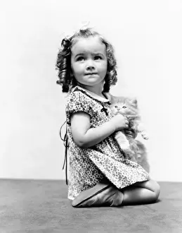 Kitten Prints: Girl with long curly hair, holding Persian kitten