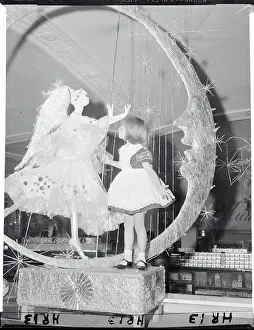 Girl Looking at Christmas Display with Angel