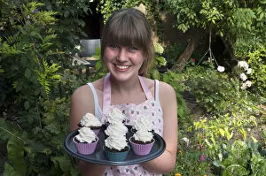 Images Dated 9th September 2014: Girl presenting her homemade Oreo brownie cupcakes
