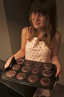 Images Dated 8th September 2014: Girl presenting her homemade Oreo brownie cupcakes