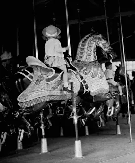 Girl riding a carousel