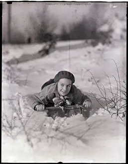Girl Riding A Sled In The Snow
