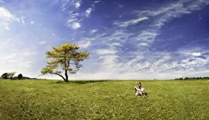 Images Dated 25th April 2010: Girl sitting in a meadow with pine tree, Altmuehltal Nature Park near Titting, Bavaria, Germany