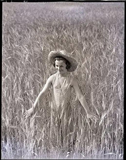 Girl Standing in Wheat Field