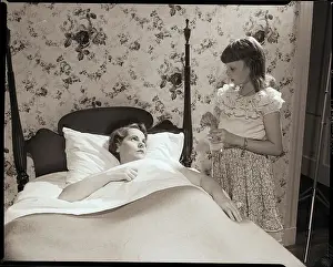 Girl Stands at Bedside of Sick Woman