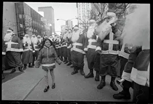 Girl Surrounded by Santa Clauses