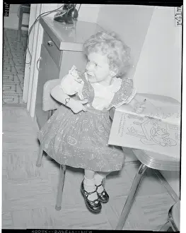 Girl at Table with Coloring Book