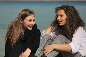 Images Dated 29th March 2014: Two girlfriends, teenagers sitting on the beach, Menton, Alpes-Maritimes, Provence Alpes, France