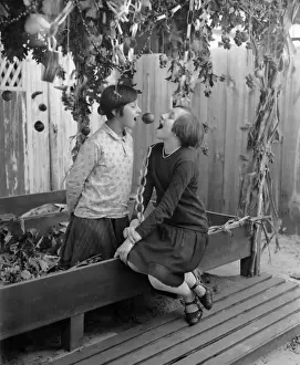 10 12 Years Prints: Two girls (10-12) eating apple