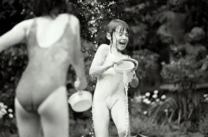 Prints of Vintage Black and White, BA09362 Stockbyte Prints: Two girls (7-9) in swimwear having water fight in garden (B&W)