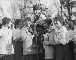 Prints of (Original Caption). Wellesley College Field Day and Halloween Party at Wellesley, Massachusetts, October 31, 1914. Eleanor Mason, captain of the 1915 hockey team, on the shoulders of her teammates Frozen Moments: A Journey Through Hockey History: Girls Hockey Team Carrying Captain