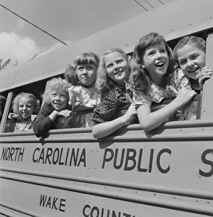 Girls Leaning Out of School Bus Windows