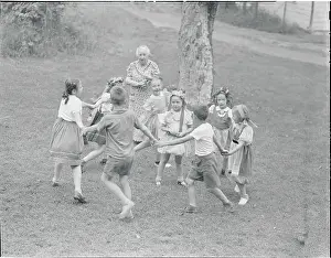 Girls Playing Circle Game with Elderly Chaperon