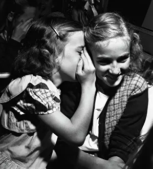 Whispering Prints: Two Girls Sharing a Secret