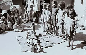 Girls Watching Boy Play With Snakes