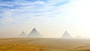 Cleopatra Prints: The Giza pyramids viewed from distance in morning haze and blue skies