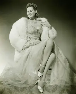 High Society Prints: Glamorous woman in evening dress showing legs, posing in studio, (B&W), portrait