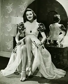 House Interior Prints: Glamorous woman in evening gown showing legs, portrait, (B&W)
