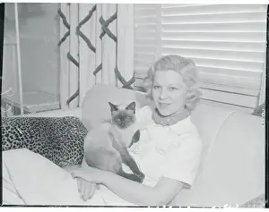 Glenda Farrell Holding Cat While Sitting on Couch