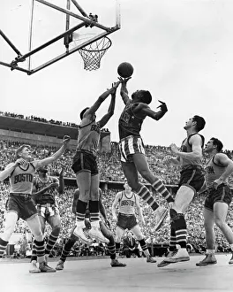 Prints of Under-the-basket view of a basketball game between the Harlem Globetrotters and the Boston Celtics during an overseas tour, West Berlin, Germany, August 22, 1951 Courtside Vibes: Stunning Basketball Prints: Globetrotters Vs Celtics In Berlin