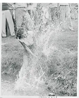 Golf Player Hitting Ball Out of a Creek