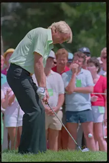 Golfer Greg Norman Preparing to Putt