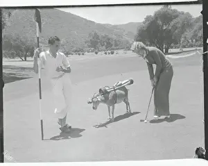 Golfers with Goat Caddie
