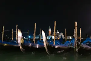 Gondolas moored by Saint Mark square with San Giorgio di Maggiore church in the background, Venice Italy