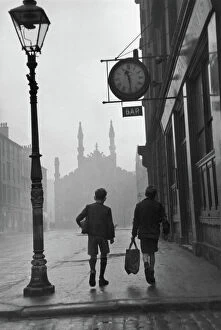 Rear View Gallery: Gorbals area of Glasgow; Two young boys walking along a street in 1948