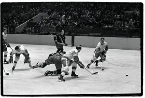Gordon Howe Races Opponent for Puck