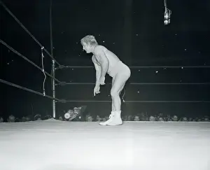Prints of (Original Caption). Gorgeous George is shown bowing to crowd after beating Dusek in wrestling match in New York. Note the hair ruffled up Grappling Through Time: A Visual Journey of Wrestling History: Gorgeous George Bowing in Ring