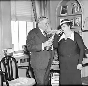 Gossip Columnist Elsa Maxwell Being Served Drink at Waldorf